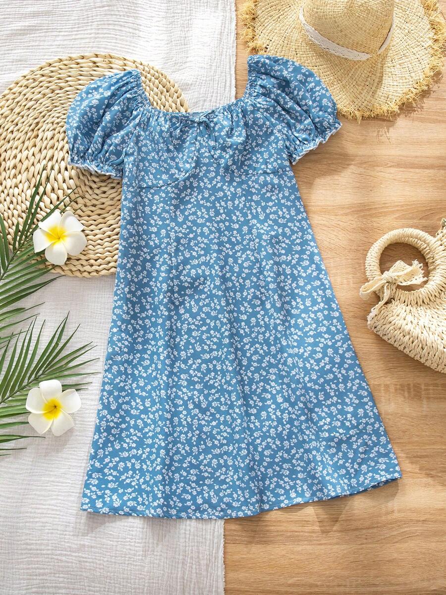Black floral all-over print midi dress for tween girls featuring puff half sleeves, spaghetti strap neckline, and an A-line silhouette.