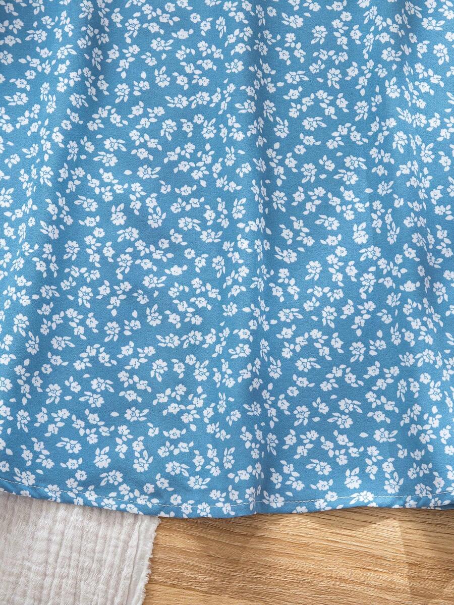 Black floral all-over print midi dress for tween girls featuring puff half sleeves, spaghetti strap neckline, and an A-line silhouette.