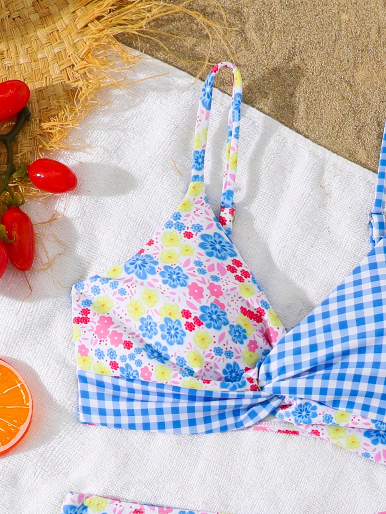 Tween girls 2-piece ditsy floral bikini set featuring a spaghetti strap top with center string detail and matching bottoms with side strings, designed for swimming, vacation, and summer wear.