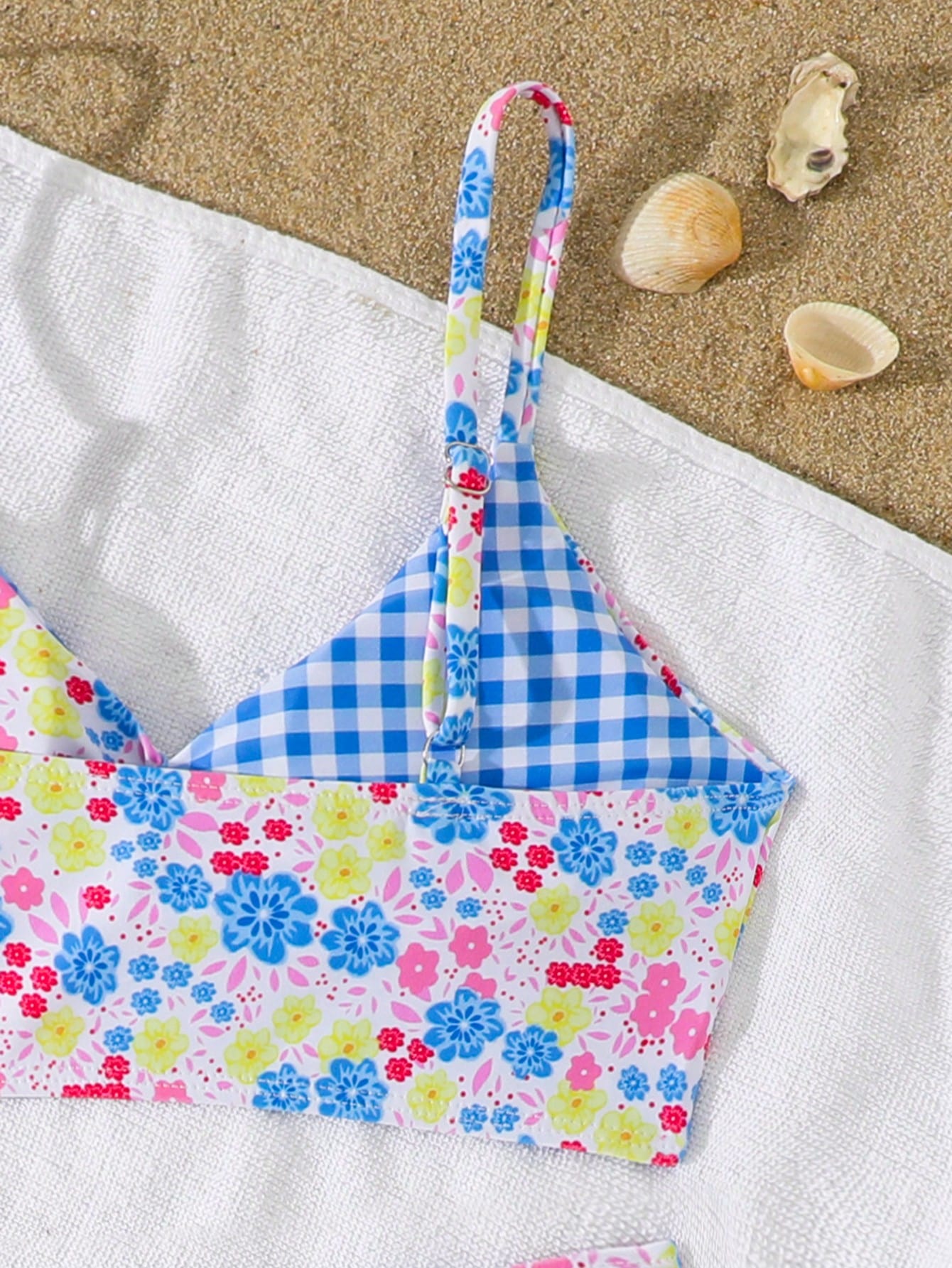 Tween girls 2-piece ditsy floral bikini set featuring a spaghetti strap top with center string detail and matching bottoms with side strings, designed for swimming, vacation, and summer wear.