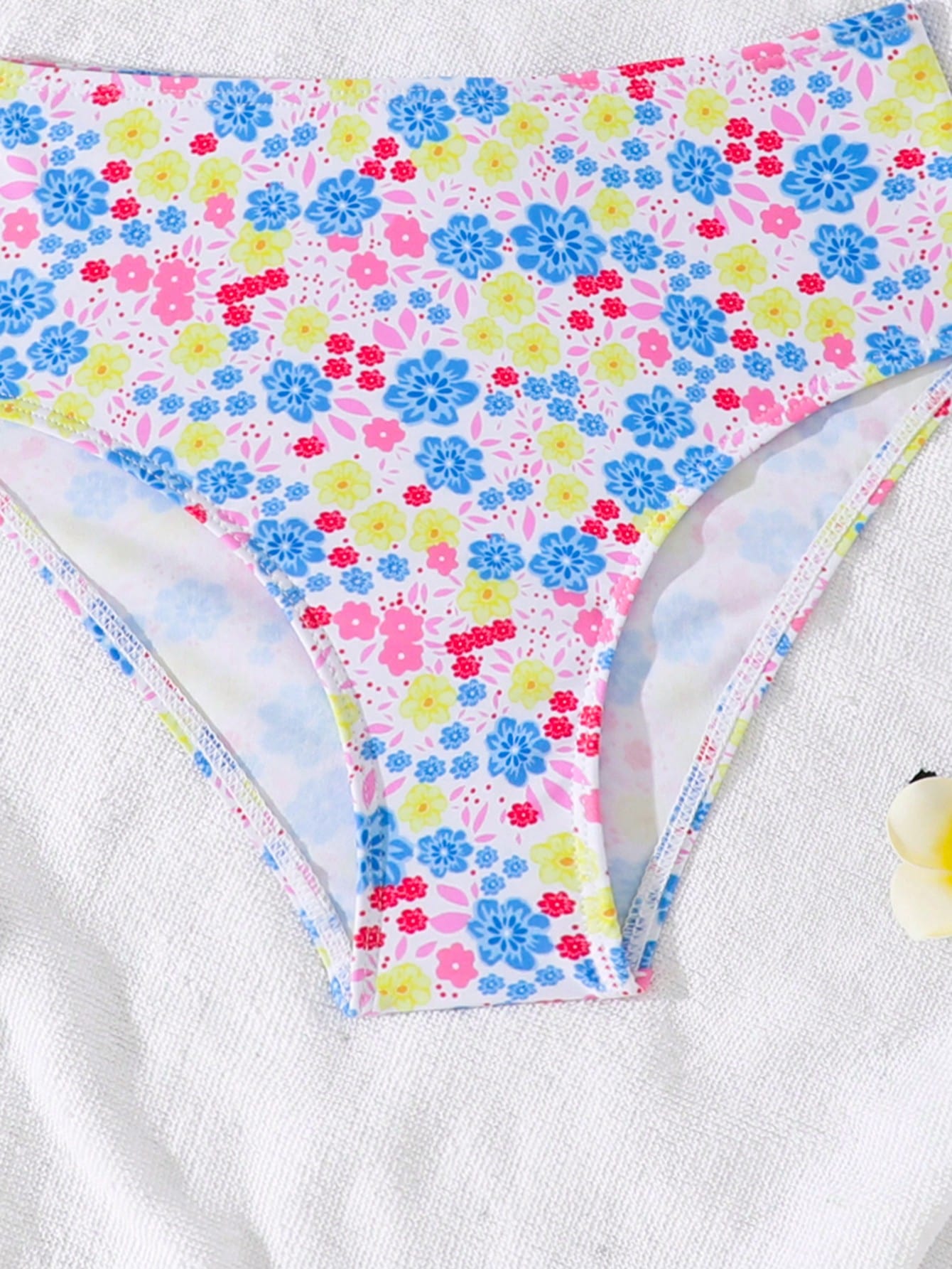 Tween girls 2-piece ditsy floral bikini set featuring a spaghetti strap top with center string detail and matching bottoms with side strings, designed for swimming, vacation, and summer wear.