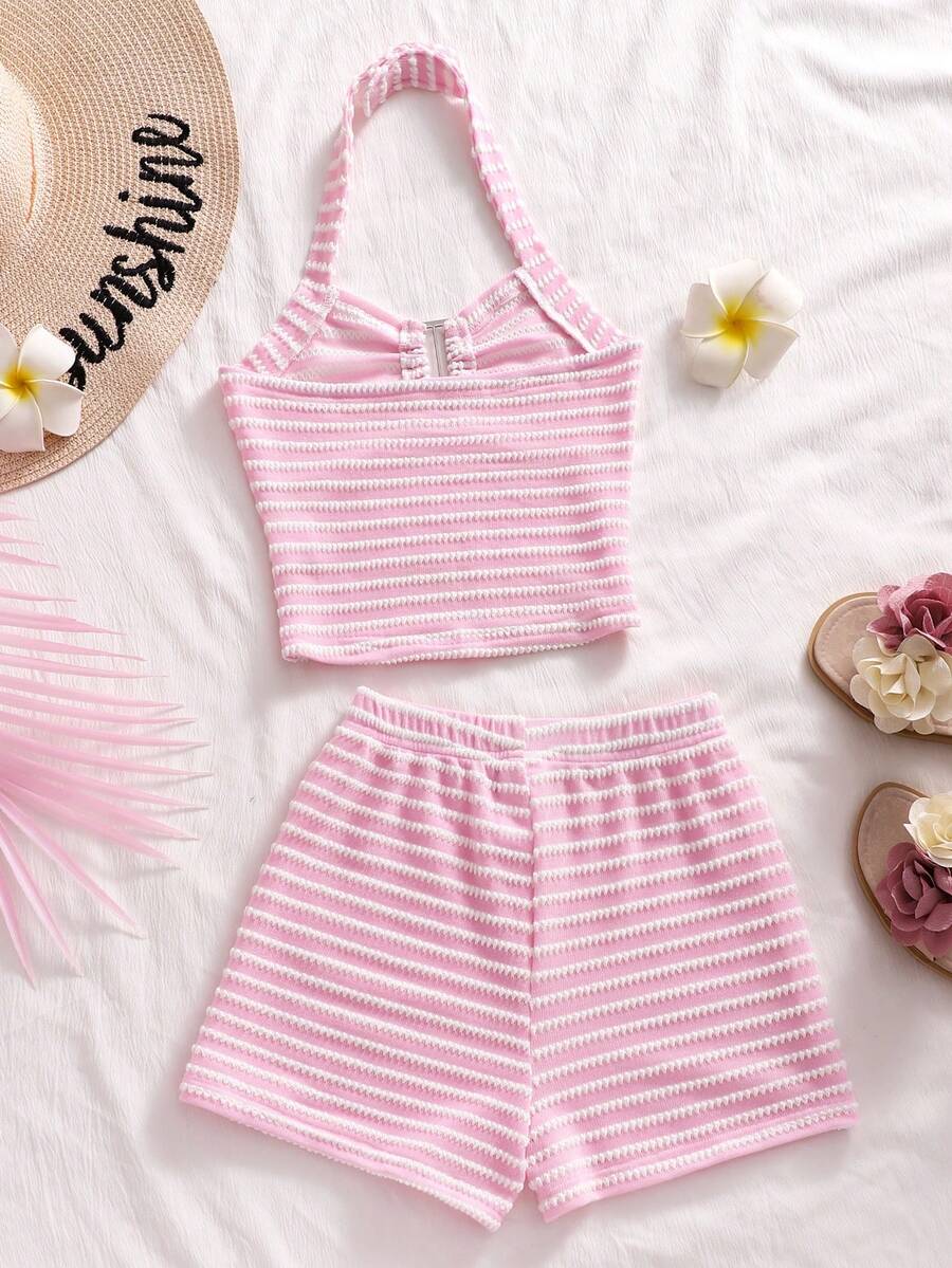 Tween girls black and white striped two-piece set featuring a spaghetti strap micro crop tank top with lettuce trim and ruffle hem paired with matching slim fit shorts.