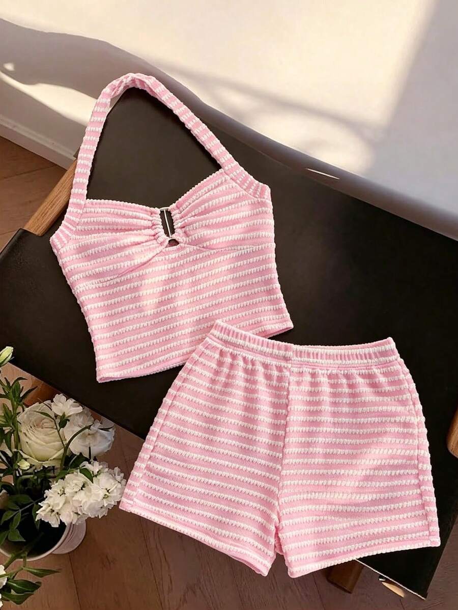 Tween girls black and white striped two-piece set featuring a spaghetti strap micro crop tank top with lettuce trim and ruffle hem paired with matching slim fit shorts.