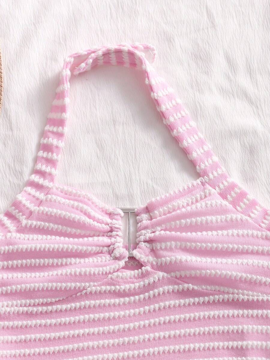 Tween girls black and white striped two-piece set featuring a spaghetti strap micro crop tank top with lettuce trim and ruffle hem paired with matching slim fit shorts.