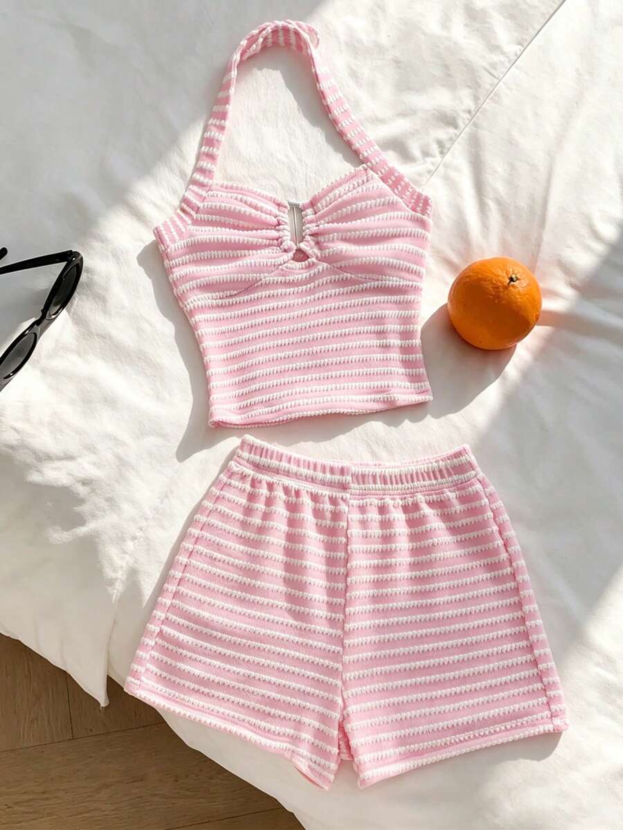 Tween girls black and white striped two-piece set featuring a spaghetti strap micro crop tank top with lettuce trim and ruffle hem paired with matching slim fit shorts.