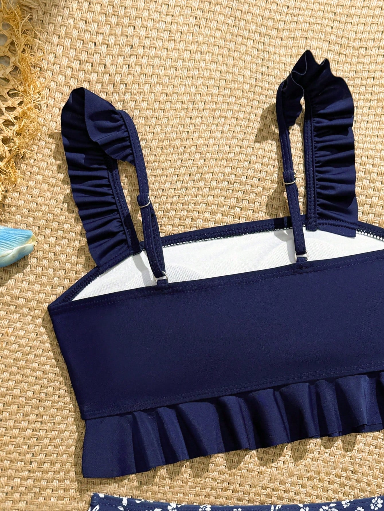 Tween girls solid color 2-piece bikini swimwear set with ruffle detail, strap neckline, wireless bikini top, and triangle mid-waist bikini bottoms; textured pattern with lined bottoms and high-stretch fabric, suitable for summer vacation.