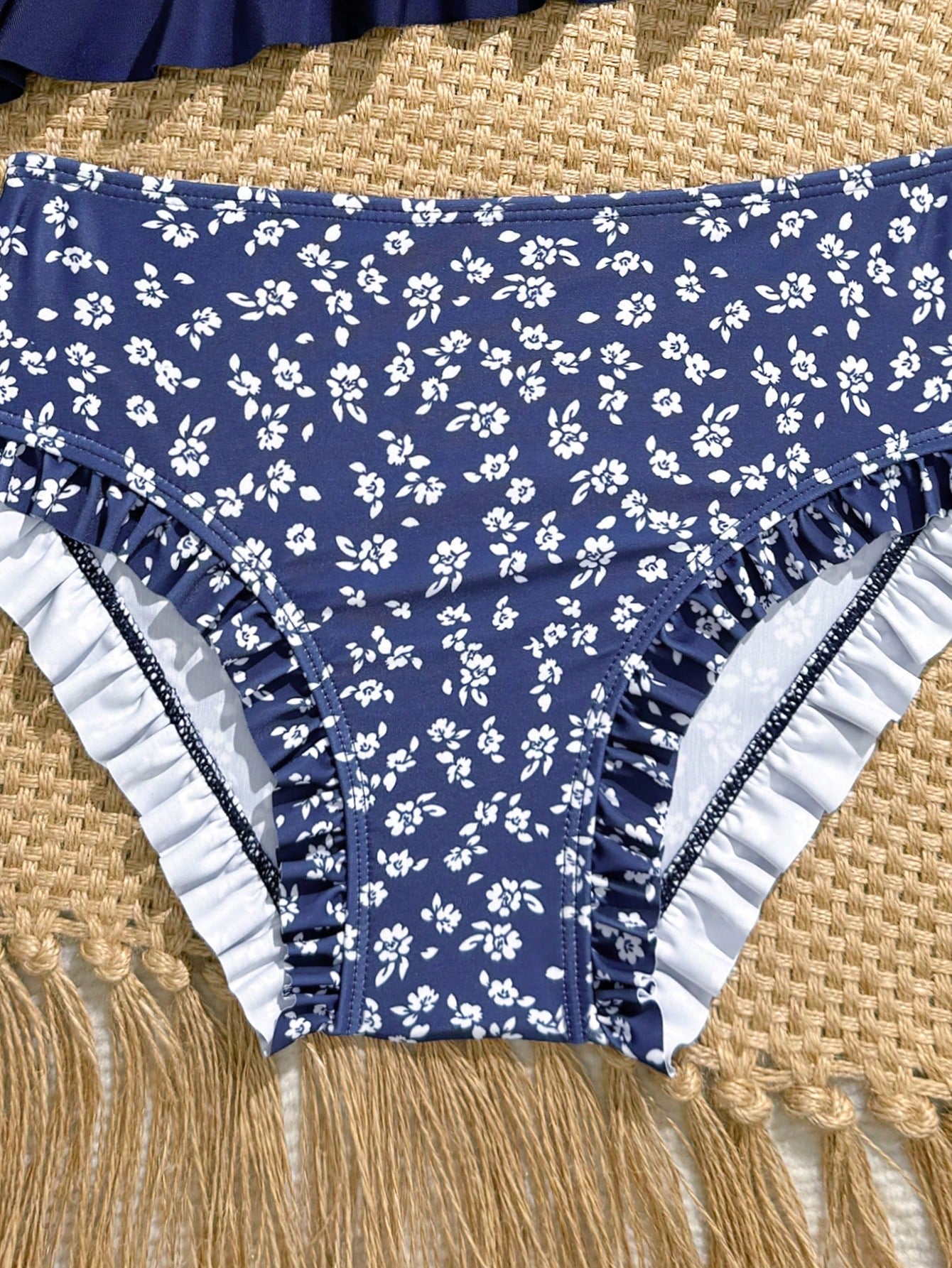 Tween girls solid color 2-piece bikini swimwear set with ruffle detail, strap neckline, wireless bikini top, and triangle mid-waist bikini bottoms; textured pattern with lined bottoms and high-stretch fabric, suitable for summer vacation.