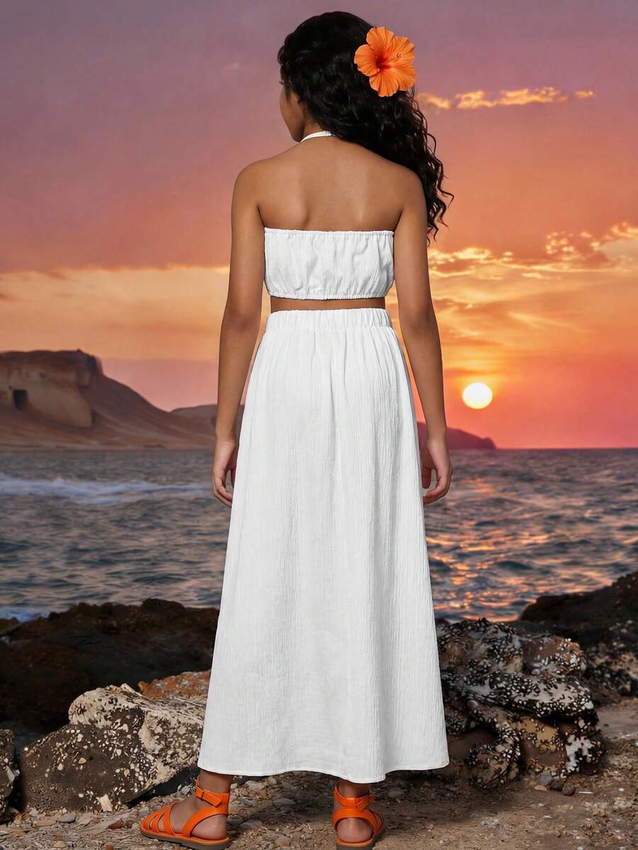 Tween girls floral halter dress with backless sleeveless design, belted high waist, shirred details, appliques, and flared A-line midi silhouette for summer vacation or graduation outfit.