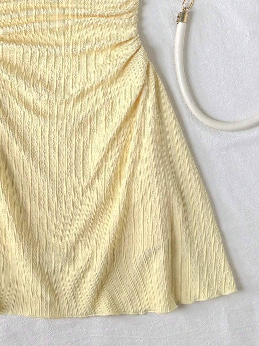 Apricot tween girls sleeveless halter cami dress with appliques, bow front, zipper detail, high waist, flared hem, and short slim fit design.