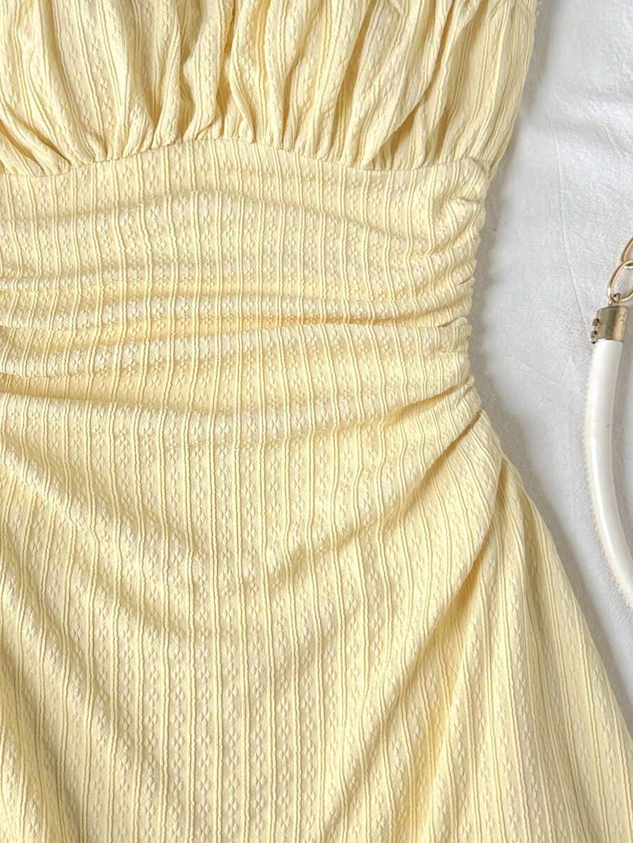 Apricot tween girls sleeveless halter cami dress with appliques, bow front, zipper detail, high waist, flared hem, and short slim fit design.