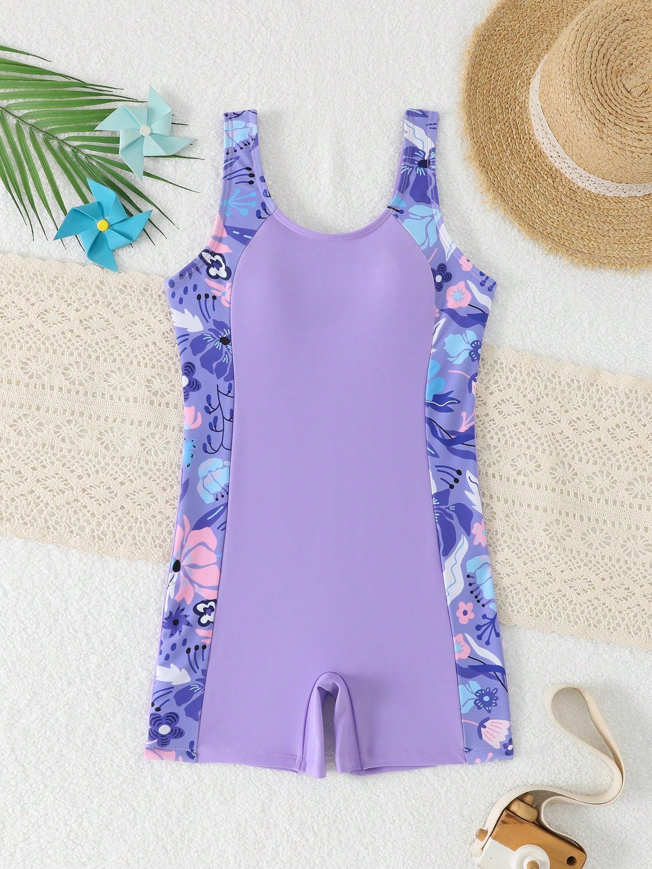Tween girls one-piece swimsuit with scoop neck, contrast piping, short length, and shorts bottom for summer beach and vacation wear