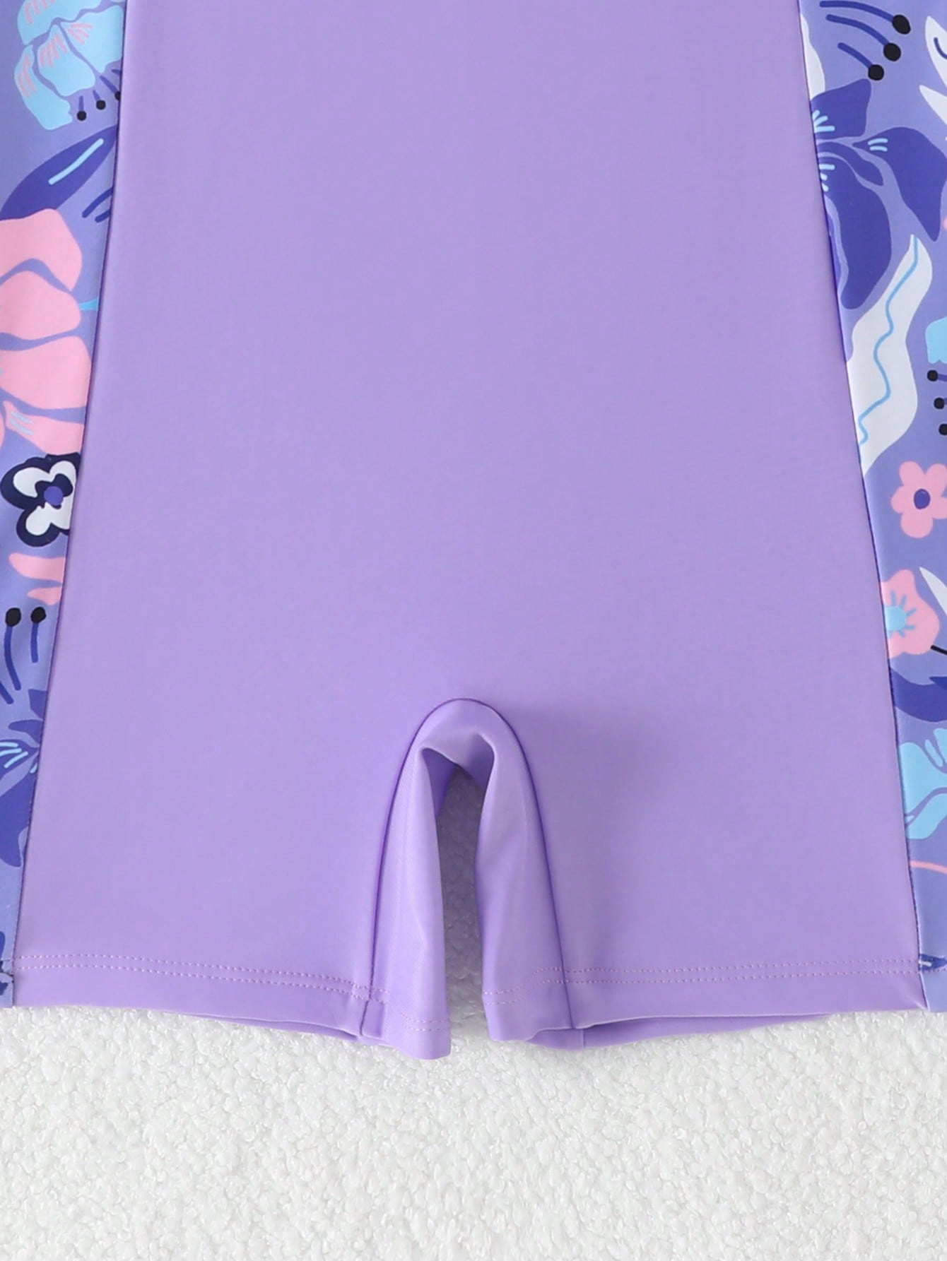 Tween girls one-piece swimsuit with scoop neck, contrast piping, short length, and shorts bottom for summer beach and vacation wear