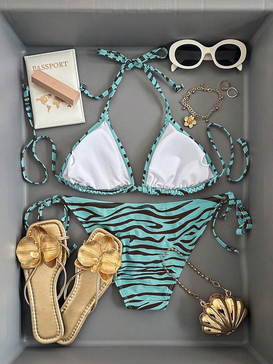 Women's black and white zebra print two-piece bikini set featuring a high waist tie-side bottom and a backless halter top with removable padding.