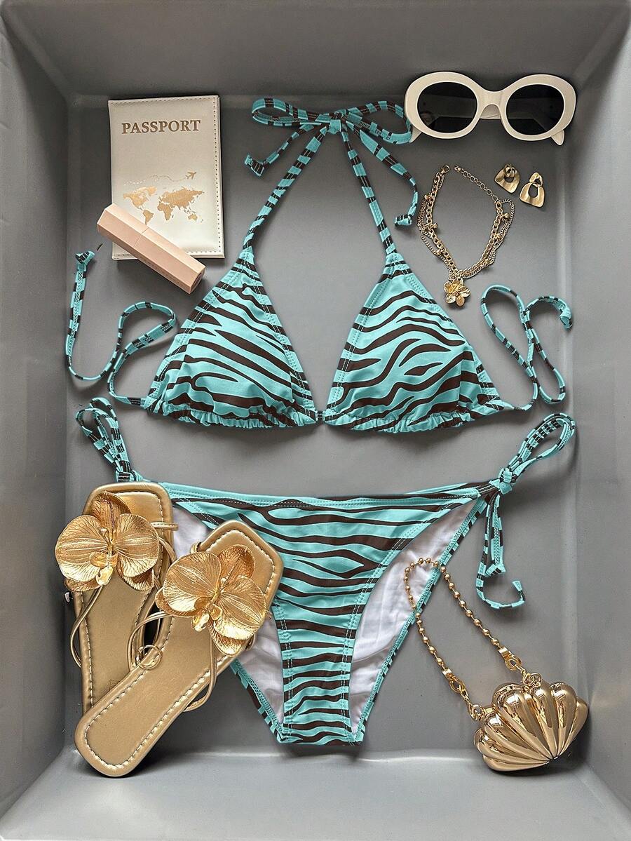 Women's black and white zebra print two-piece bikini set featuring a high waist tie-side bottom and a backless halter top with removable padding.