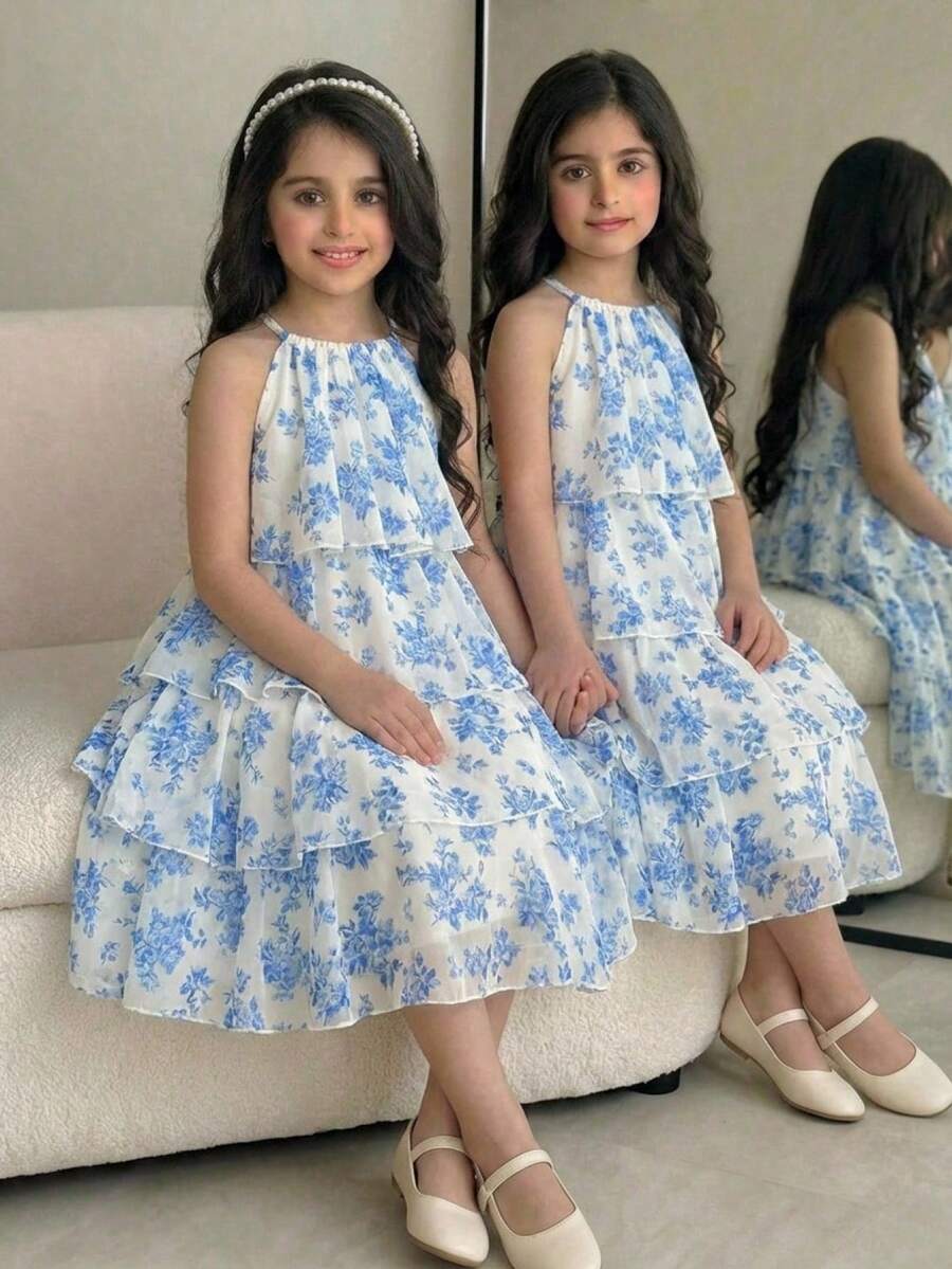 Apricot all-over floral print midi dress for tween girls featuring a sleeveless V-neckline, high waist, button details, and tiered A-line skirt.