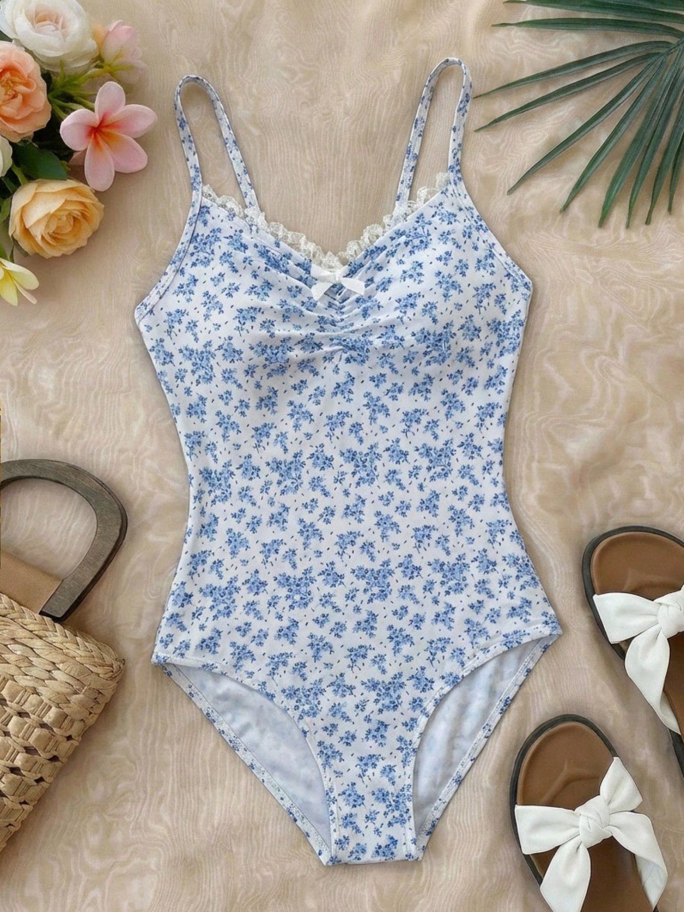 Tween girls' one-piece swimsuit featuring a ruffle splice front, ruched detailing, bow accent, contrast lace trim, and spaghetti straps.