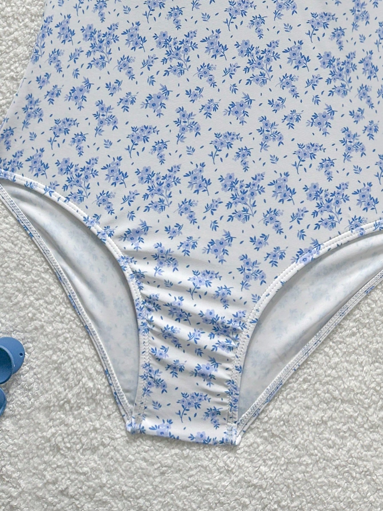Tween girls' one-piece swimsuit featuring a ruffle splice front, ruched detailing, bow accent, contrast lace trim, and spaghetti straps.