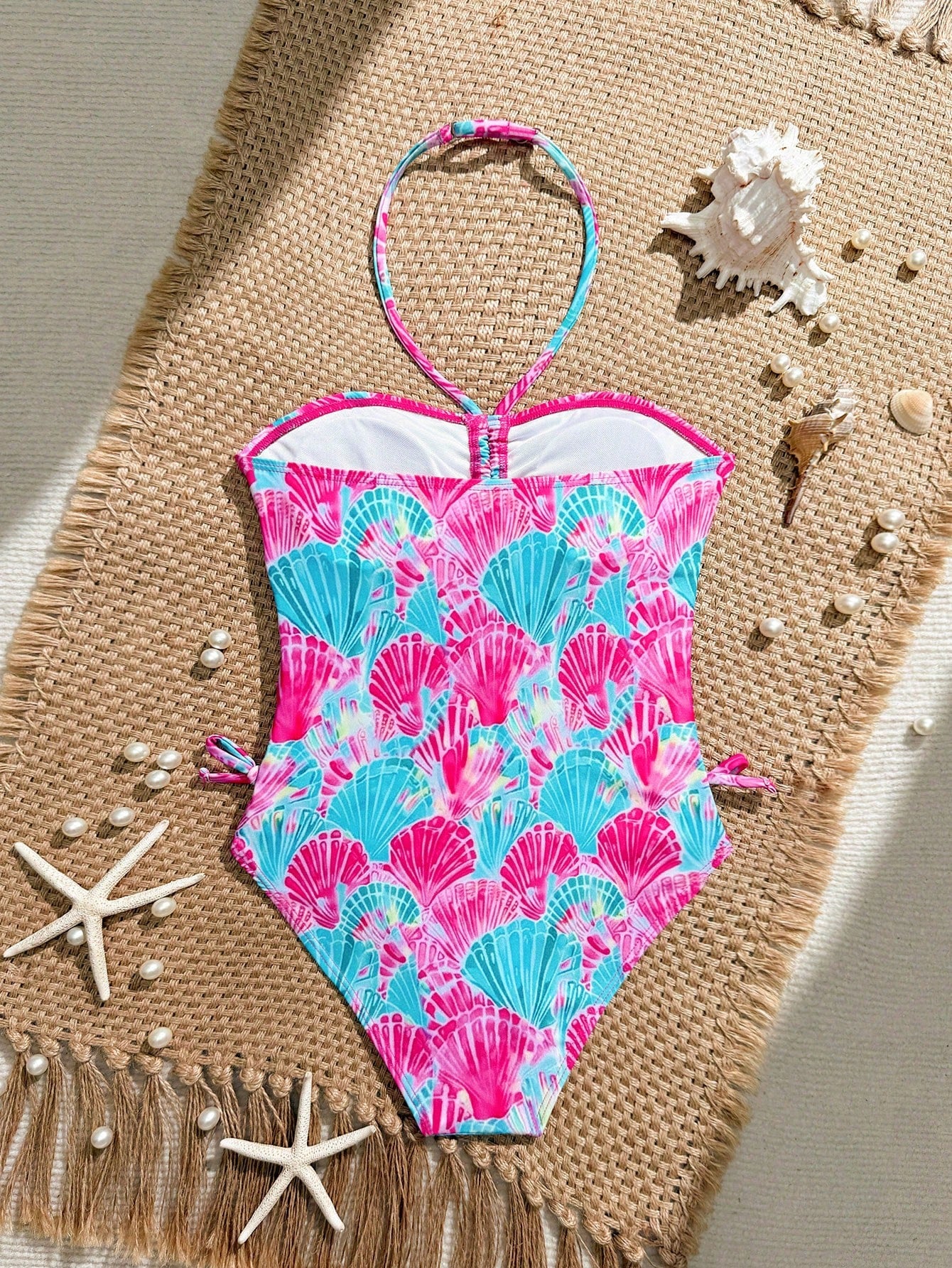 Blue halter one-piece swimsuit for tween girls with full geometric print, wireless bra design, mid-waist bottom, and medium-stretch fabric for beach and pool wear.
