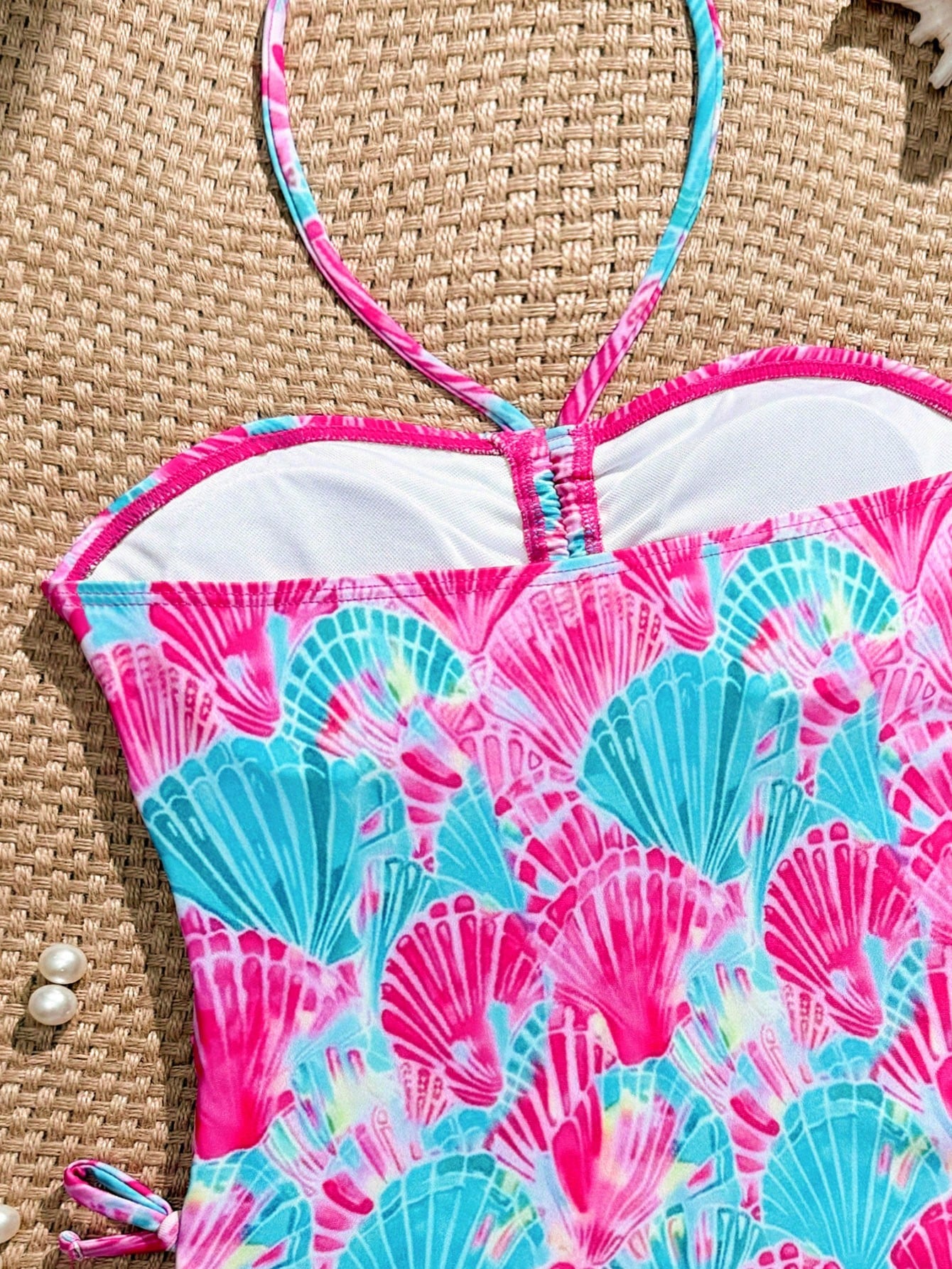 Blue halter one-piece swimsuit for tween girls with full geometric print, wireless bra design, mid-waist bottom, and medium-stretch fabric for beach and pool wear.