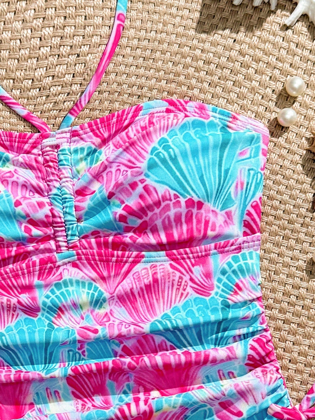Blue halter one-piece swimsuit for tween girls with full geometric print, wireless bra design, mid-waist bottom, and medium-stretch fabric for beach and pool wear.