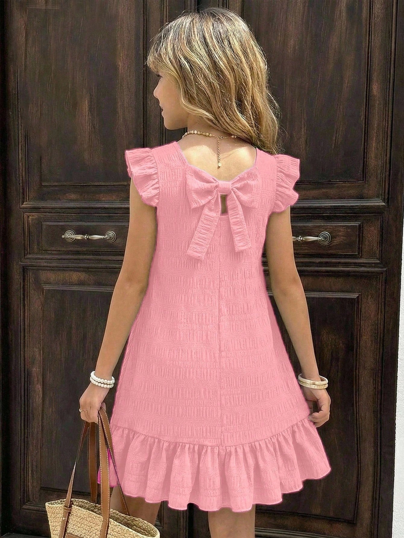 Tween girls apricot vacation midi dress featuring a round neck, cut out details, ruffle flounce accents, and geometric pattern.