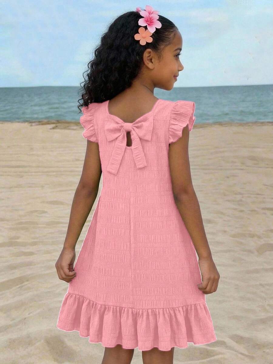 Tween girls apricot vacation midi dress featuring a round neck, cut out details, ruffle flounce accents, and geometric pattern.