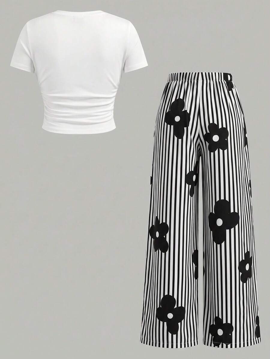 Tween girl 2-piece summer set featuring a white printed short-sleeve T-shirt and black and white striped long pants.