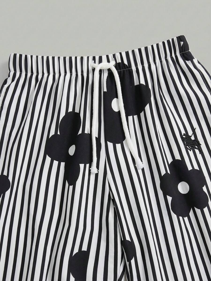 Tween girl 2-piece summer set featuring a white printed short-sleeve T-shirt and black and white striped long pants.