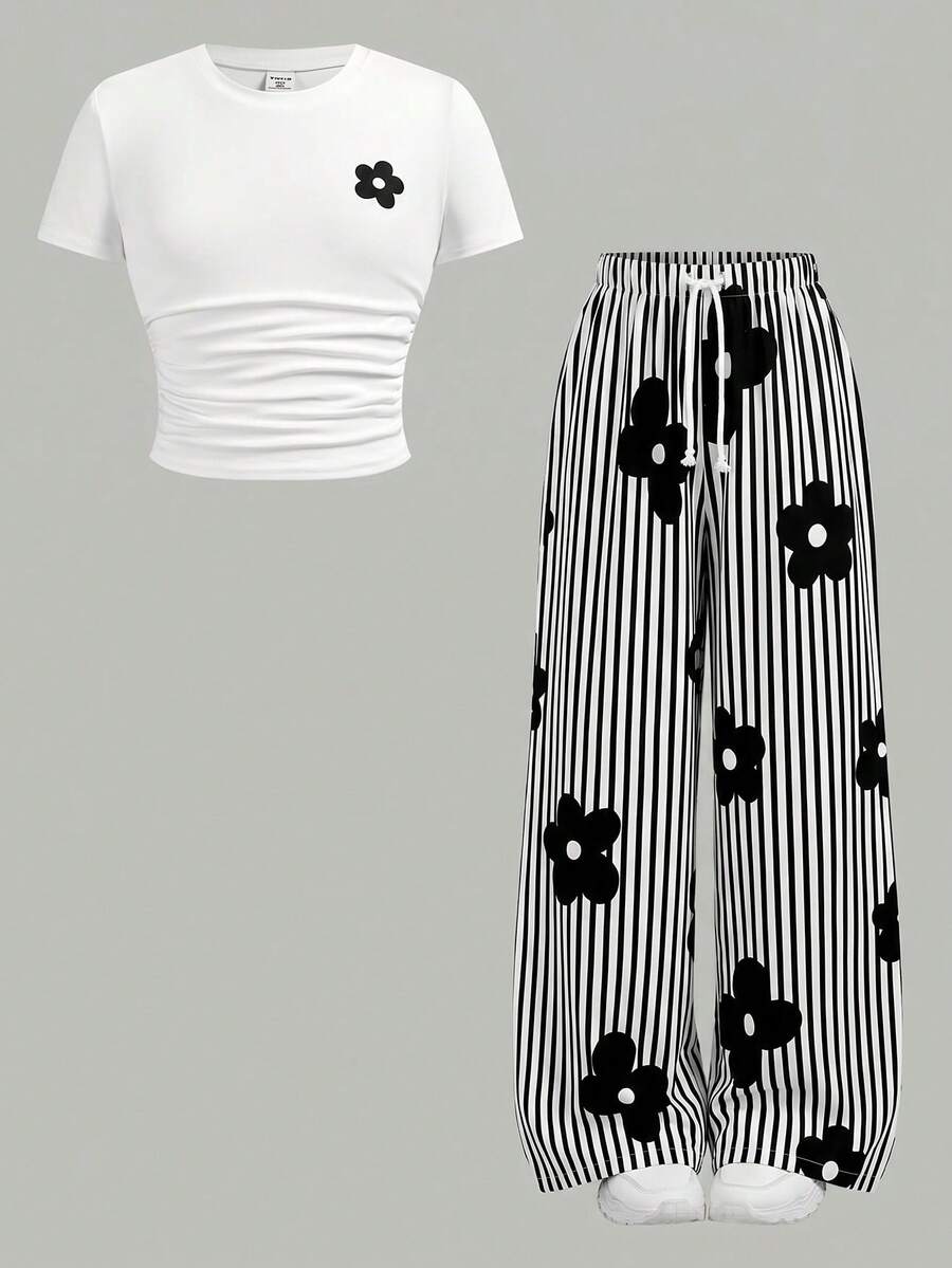 Tween girl 2-piece summer set featuring a white printed short-sleeve T-shirt and black and white striped long pants.