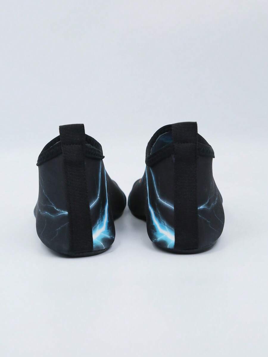 Multicolor boys water shoes featuring a cartoon Tyrannosaurus Rex print, breathable Lycra upper, slip-on stretch collar, and flexible non-slip rubber outsole.