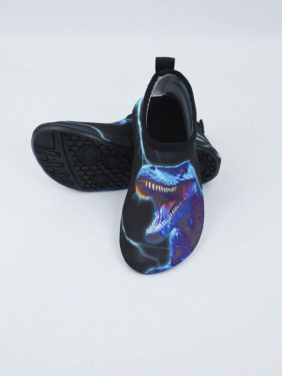 Multicolor boys water shoes featuring a cartoon Tyrannosaurus Rex print, breathable Lycra upper, slip-on stretch collar, and flexible non-slip rubber outsole.
