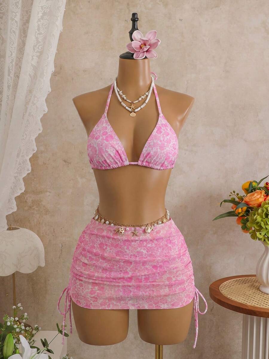 Women's black 3-piece bikini set featuring a halter triangle top with removable padding, high-waisted bottoms, and a knee-length mesh skirt with tie details.