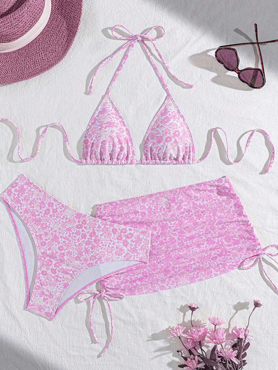 Women's black 3-piece bikini set featuring a halter triangle top with removable padding, high-waisted bottoms, and a knee-length mesh skirt with tie details.