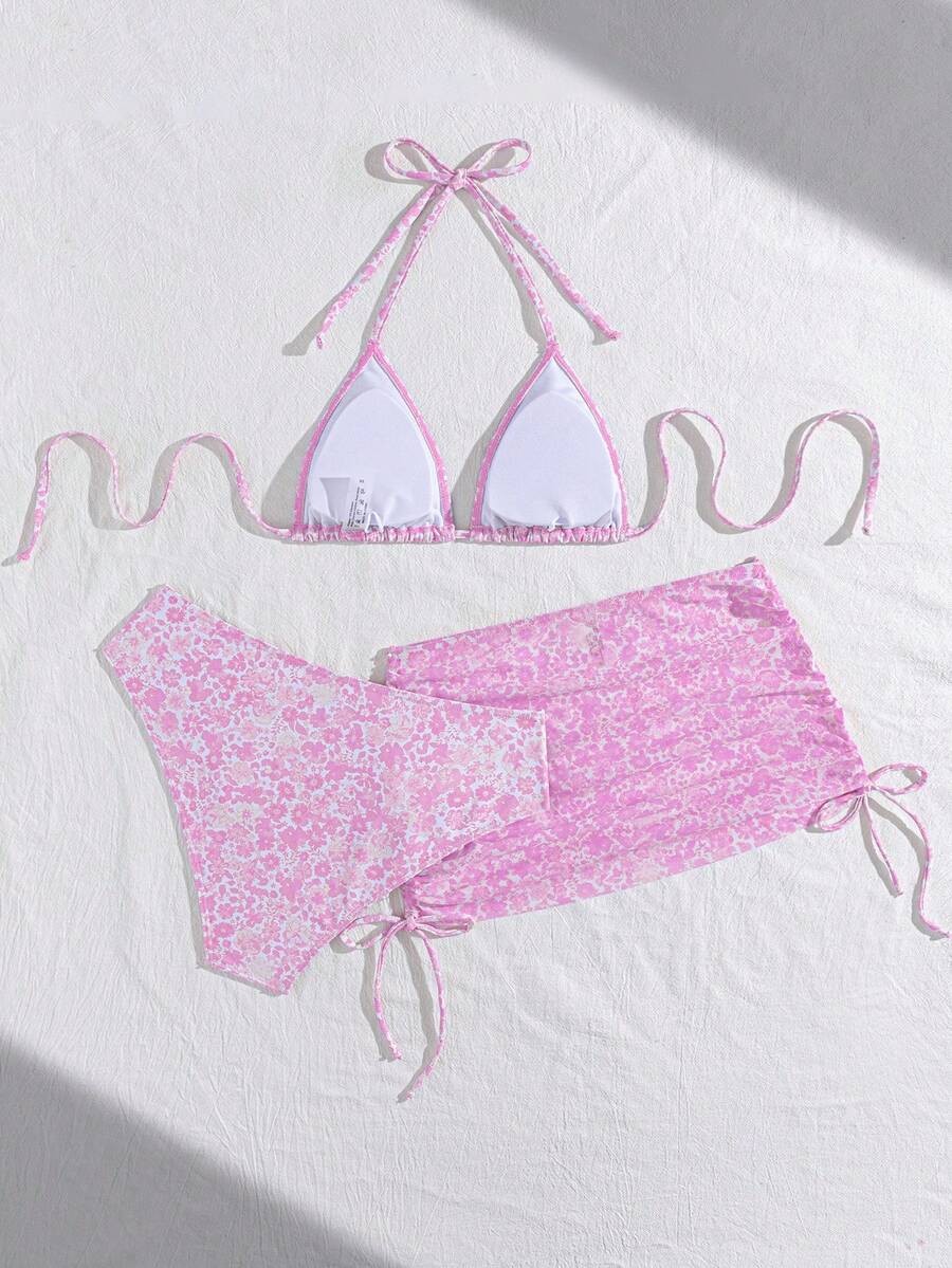 Women's black 3-piece bikini set featuring a halter triangle top with removable padding, high-waisted bottoms, and a knee-length mesh skirt with tie details.