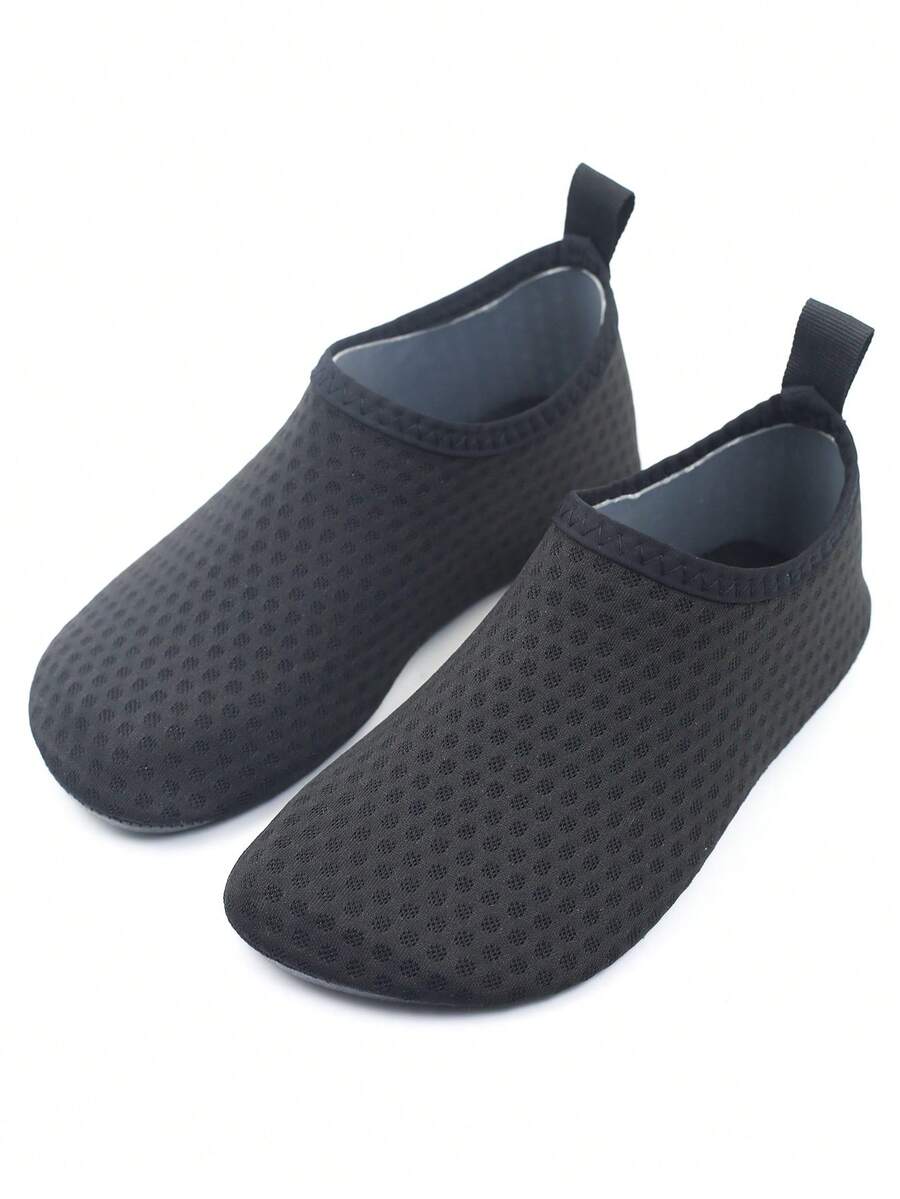 Pair of lightweight slip-on kids water shoes with breathable upper and non-slip outsole for summer beach and pool wear.