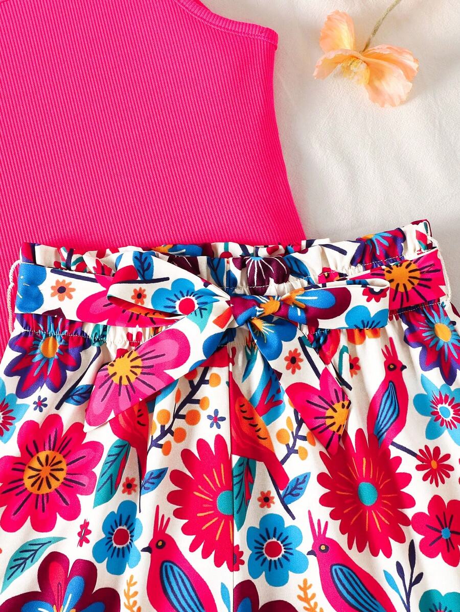 Tween girl wearing a casual 2-piece set featuring a black rib-knit scoop neck tank top and leopard print paperbag waist shorts with a matching belt.