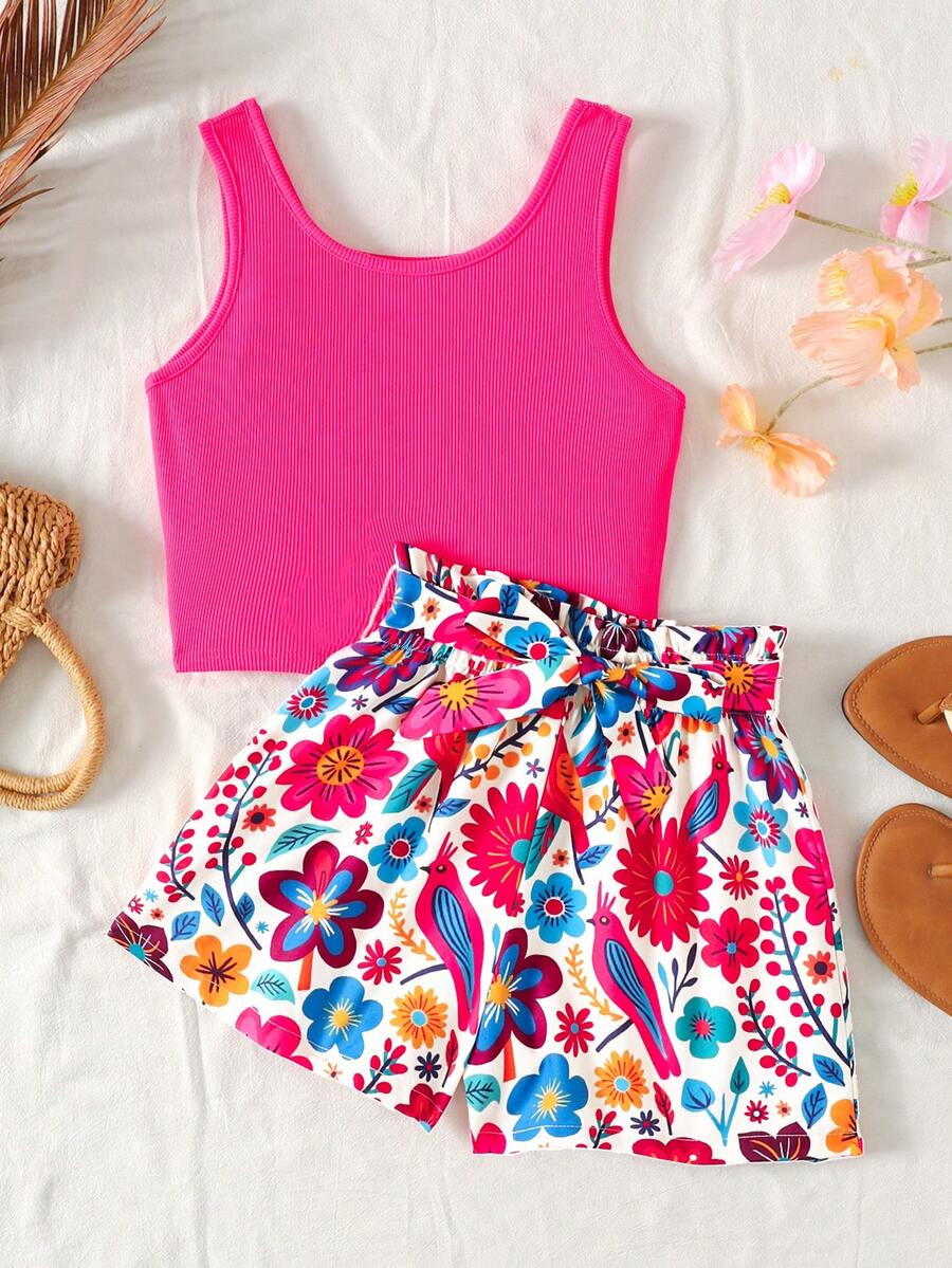 Tween girl wearing a casual 2-piece set featuring a black rib-knit scoop neck tank top and leopard print paperbag waist shorts with a matching belt.