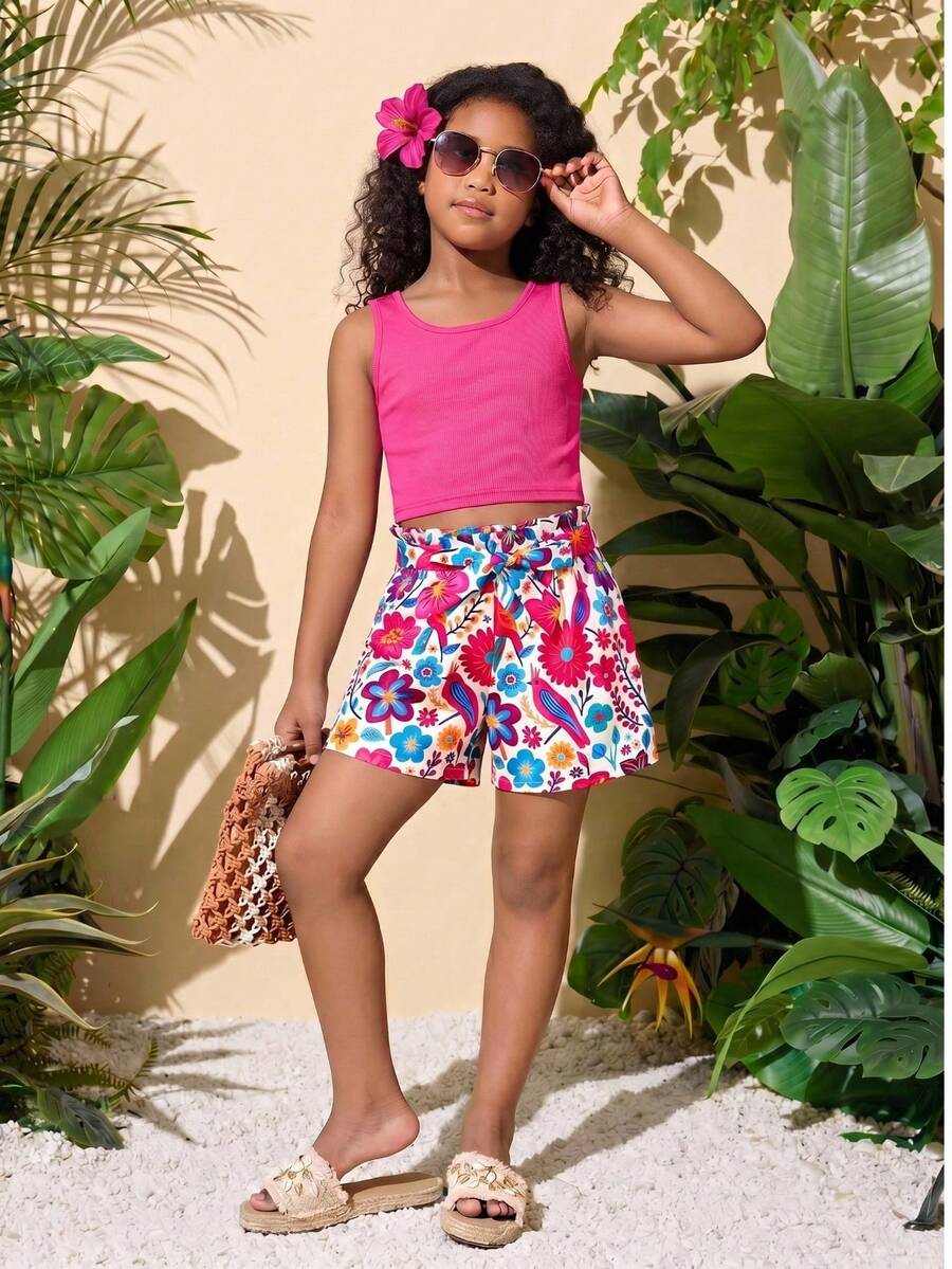 Tween girl wearing a casual 2-piece set featuring a black rib-knit scoop neck tank top and leopard print paperbag waist shorts with a matching belt.