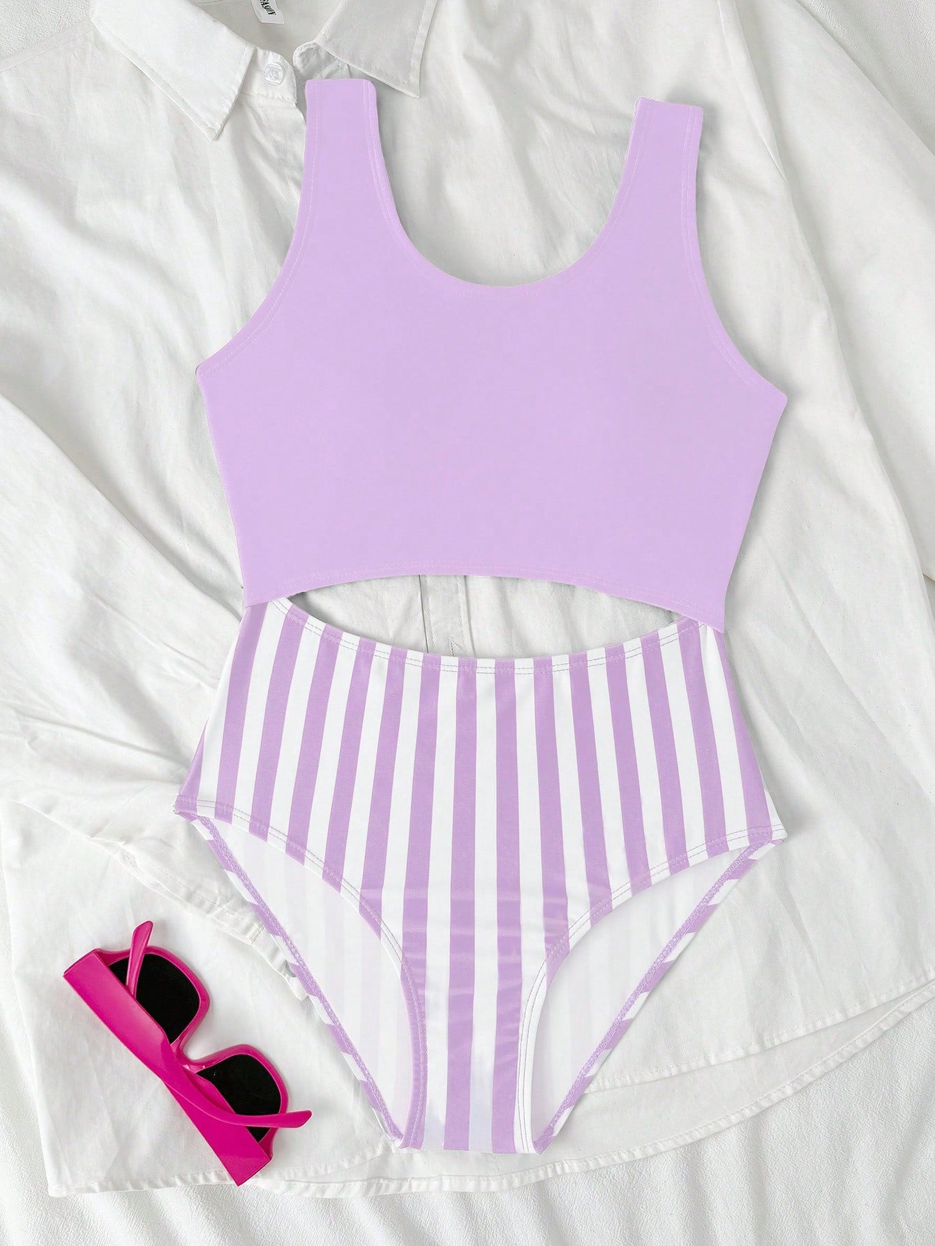 Purple tween girls one-piece swimsuit with asymmetrical neckline, cut-out waist, striped pattern, fitted silhouette, and lined body.