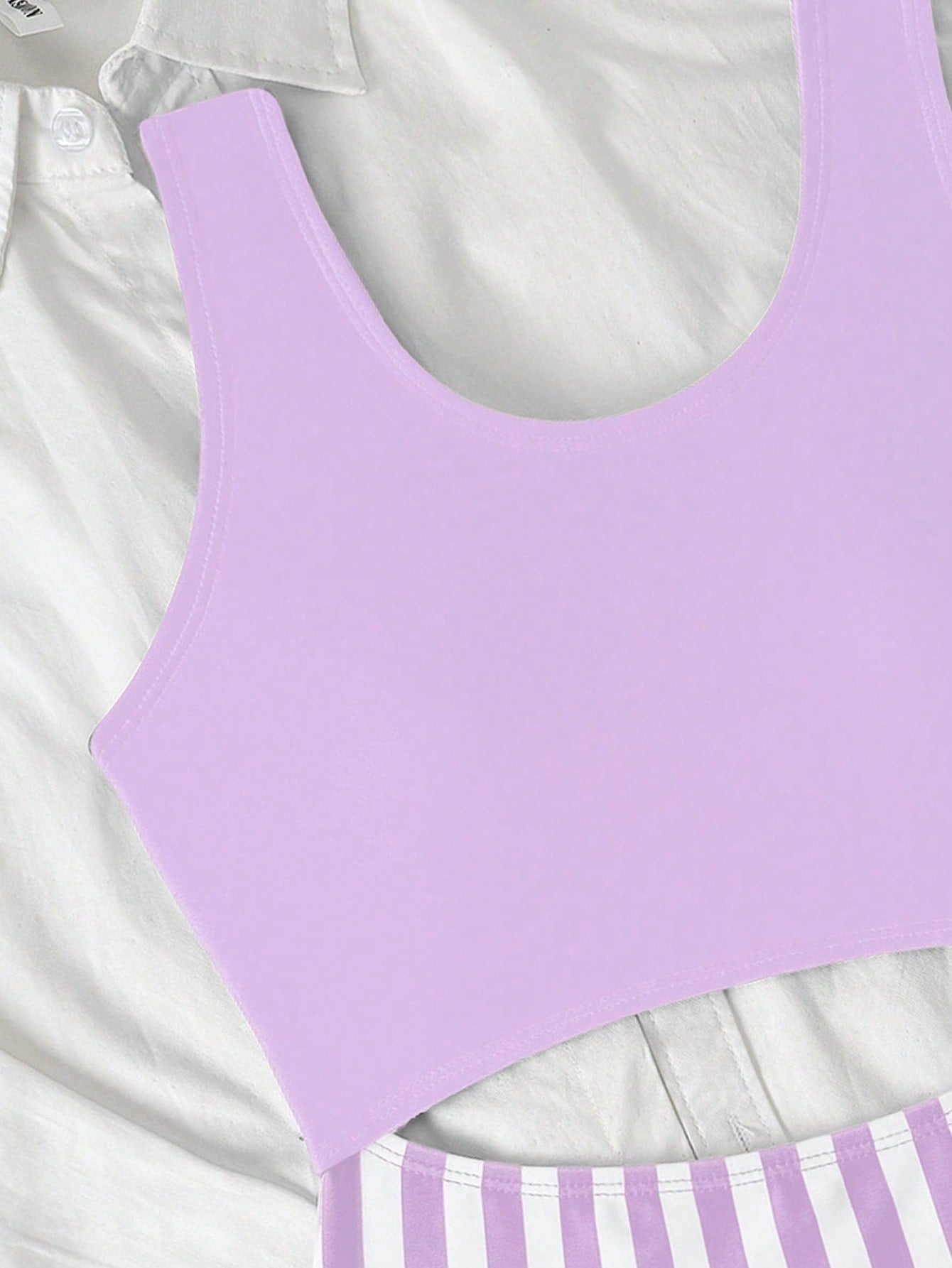 Purple tween girls one-piece swimsuit with asymmetrical neckline, cut-out waist, striped pattern, fitted silhouette, and lined body.