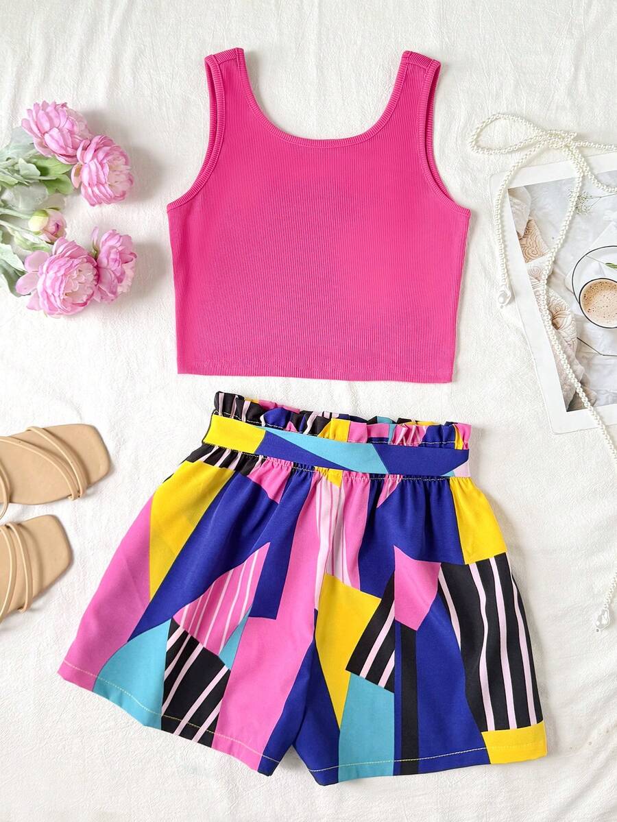 Tween girl summer two-piece outfit featuring a white scoop neck tank top and green ditsy floral print paperbag waist shorts with belt.