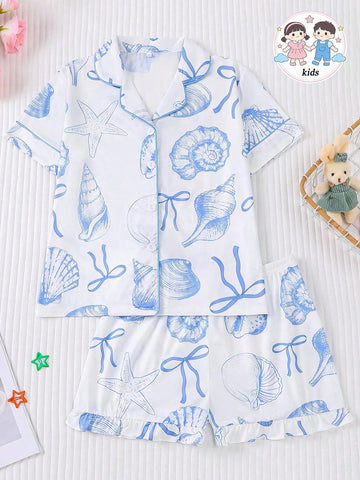 White 2-piece tween girl summer pajama set with blue ocean and seashell print featuring a short sleeve lapel cardigan top and matching elastic waist shorts.