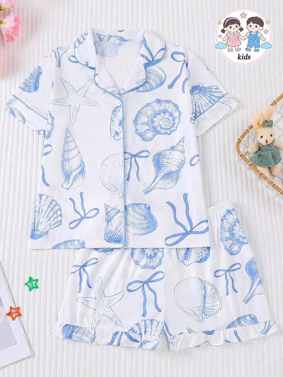 White 2-piece tween girl summer pajama set with blue ocean and seashell print featuring a short sleeve lapel cardigan top and matching elastic waist shorts.