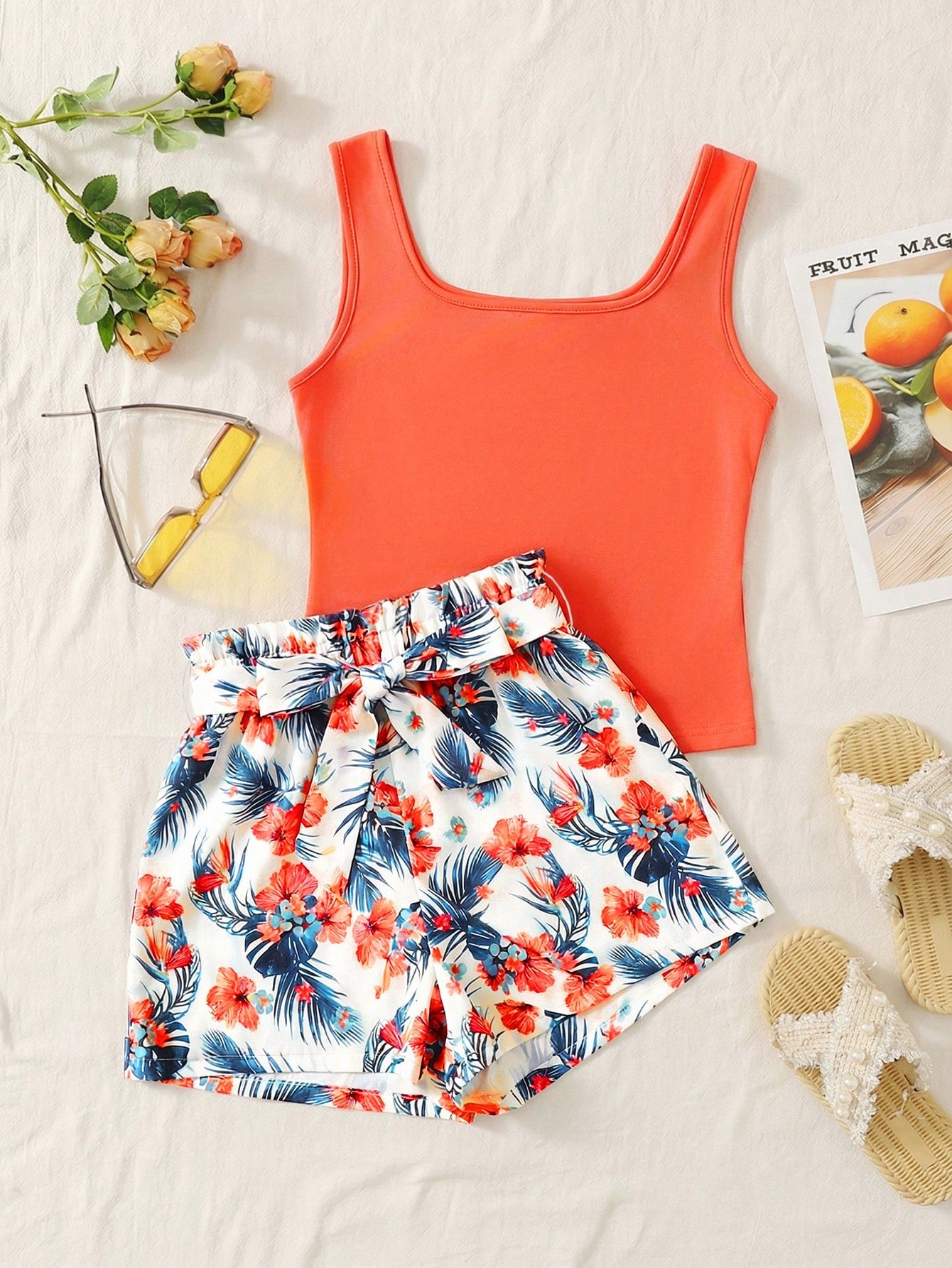 Tween girls 2-piece summer set featuring a turquoise blue ribbed tank top and tropical leaf pattern belted shorts.