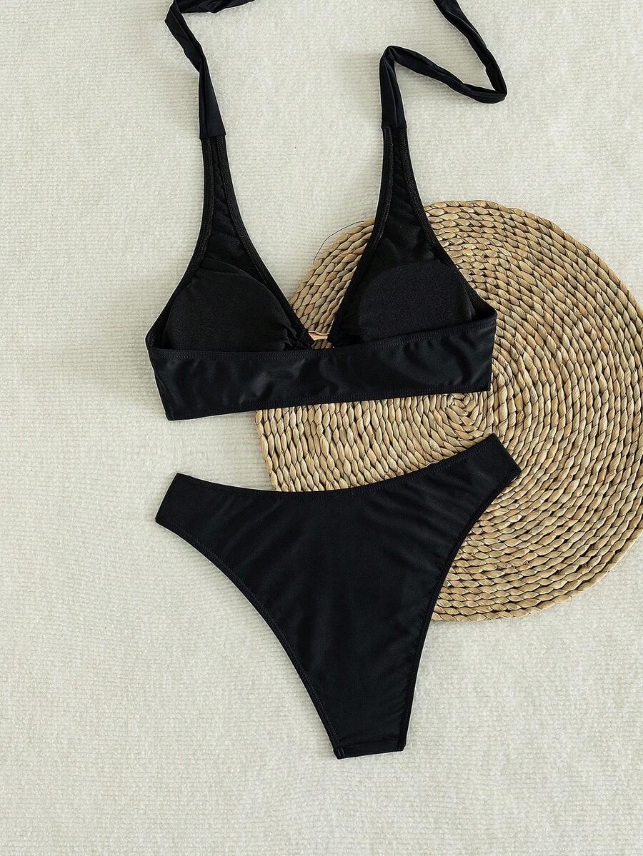 Women's 2-piece solid color halter bikini set featuring a backless tie-back wireless top and mid-waist swimsuit bottoms.