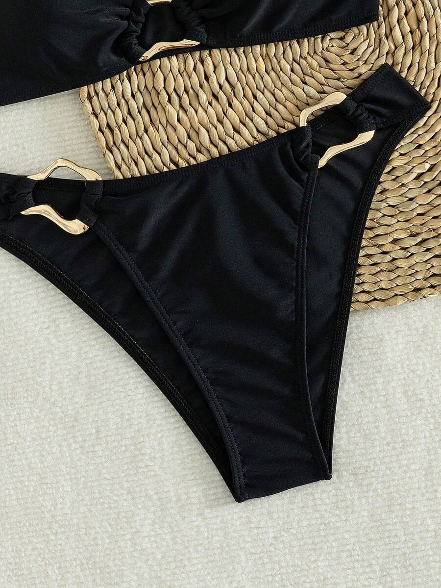 Women's 2-piece solid color halter bikini set featuring a backless tie-back wireless top and mid-waist swimsuit bottoms.
