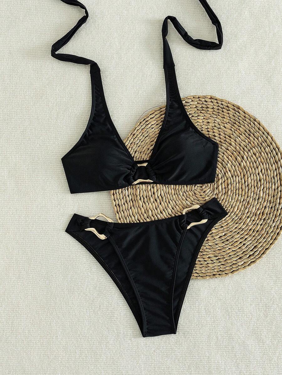 Women's 2-piece solid color halter bikini set featuring a backless tie-back wireless top and mid-waist swimsuit bottoms.