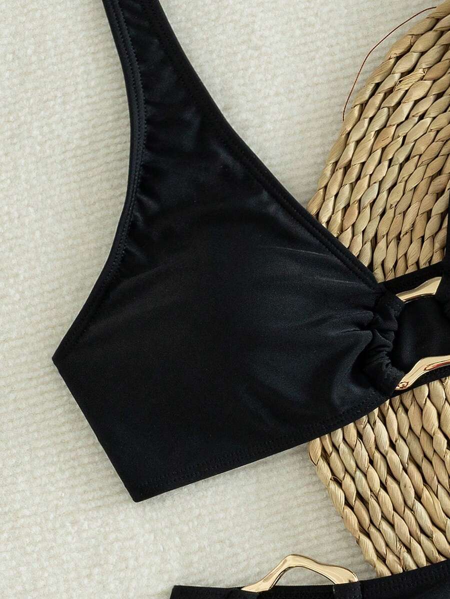 Women's 2-piece solid color halter bikini set featuring a backless tie-back wireless top and mid-waist swimsuit bottoms.