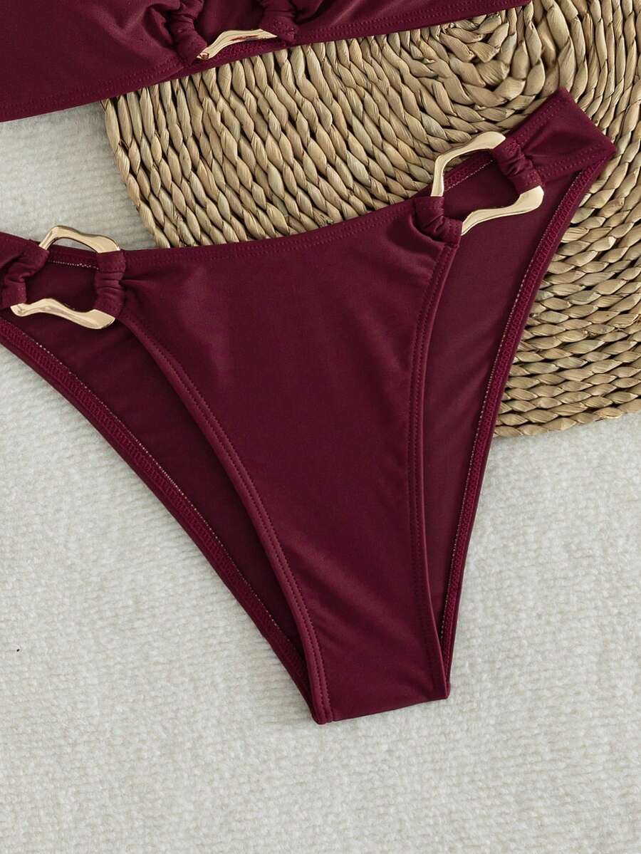 Women's 2-piece solid color halter bikini set featuring a backless tie-back wireless top and mid-waist swimsuit bottoms.