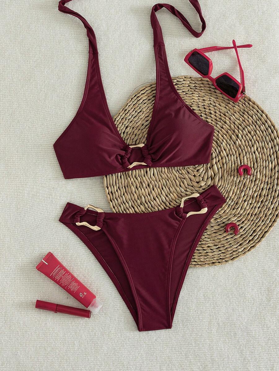 Women's 2-piece solid color halter bikini set featuring a backless tie-back wireless top and mid-waist swimsuit bottoms.